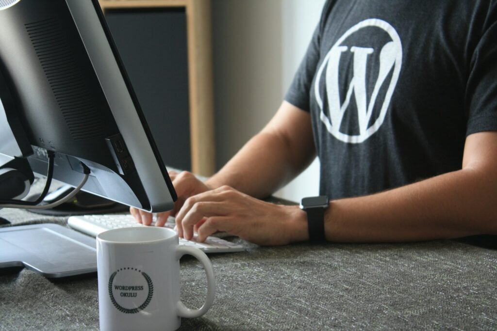 WordPress developer in black and white t-shirt using computer